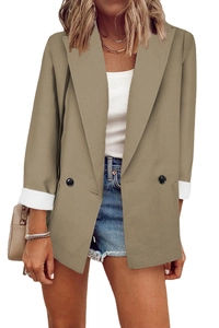 Detailed close-up of khaki blazer featuring double-breasted buttons and folded white cuffs