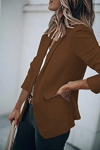 Detail of deep brown blazer featuring a classic lapel collar and side flap pocket