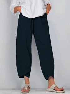 Detailed view of women's linen wide-leg pants featuring a unique crossover hem design