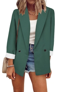 Front detail of dark green double-breasted blazer with contrast white turned cuffs
