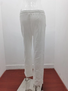 Detailed view of elastic waistband and linen texture on white wide-leg casual pants