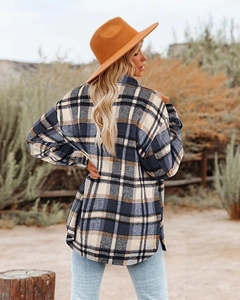 Side view of heavy plaid shacket featuring dropped shoulders and side slit hem