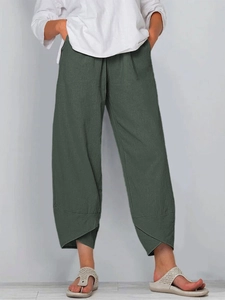 Detail view of wide-leg cotton linen trousers with unique overlapping hem design