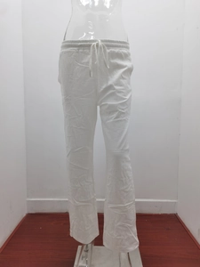Detail view of the white cotton linen wide-leg trousers featuring adjustable drawstring waist