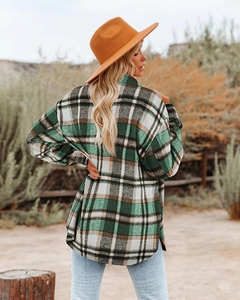 Rear view of green and brown plaid oversized wool shacket in a vintage outdoor setting