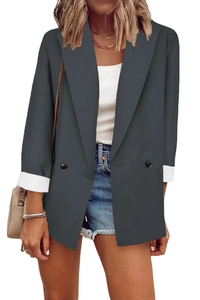 Detail of dark grey blazer featuring classic double-breasted buttons and white contrast cuffs