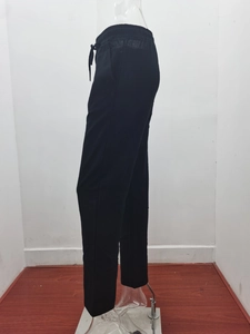 Detail showing elastic waist with adjustable drawstring on black linen trousers