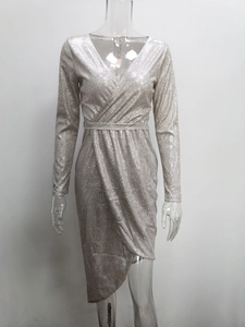 Close-up of silver sequin dress featuring a deep V-neck and glittery texture finish