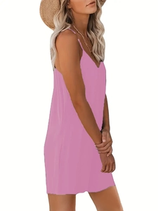 Side view of pink V-neck sleeveless summer romper with thin straps and straw hat accessories