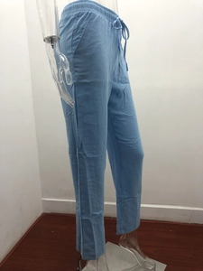 Detail of light blue linen trousers showing drawstring elastic waist and side pockets