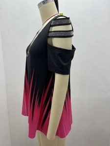 Detail of cold shoulder design with sparkly straps and V-neck zipper on black floral top