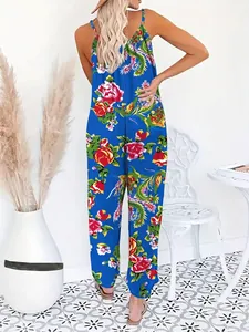 Detail of royal blue jumpsuit showing the deep V backless cut and vibrant floral patterns