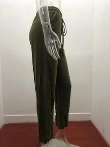 Detail of olive green linen fabric texture and adjustable drawstring waistband