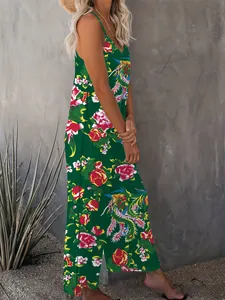 Detail of dark green V-neck jumpsuit featuring vintage floral patterns and high side slit