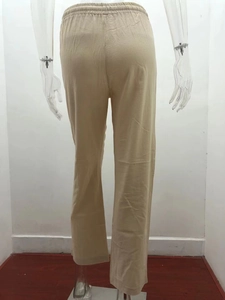 Back view of beige linen-blend trousers featuring elastic drawstring waist and loose wide-leg cut