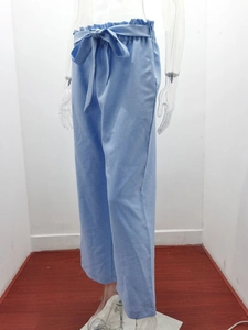 Detail of light blue paperbag waist wide leg trousers with matching tie belt