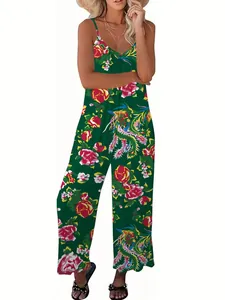 Detail view of tropical floral print on a dark green V-neck wide-leg jumpsuits fabric