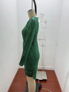 Detail showing deep green sequin fabric texture on a long sleeve slim fit party dress