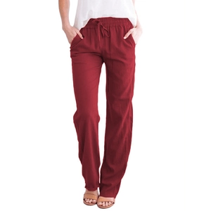 Detail of solid dark red cotton linen trousers with elastic drawstring waist and side pockets