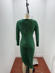 Detail of the glitter emerald green dress featuring a back zipper and sequined fabric texture