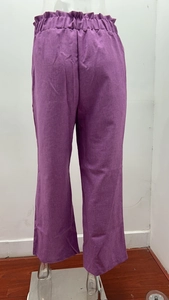 Detailed view of elastic high waist with ruffle trim on purple linen wide leg trousers
