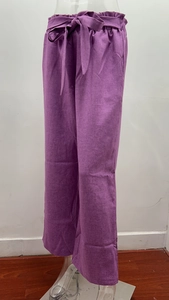 Detail of purple linen wide-leg pants featuring an elastic high waist with drawstring belt