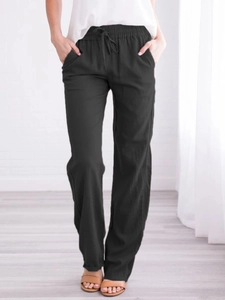 Detail of black cotton linen trousers showing elastic drawstring waist and side pockets