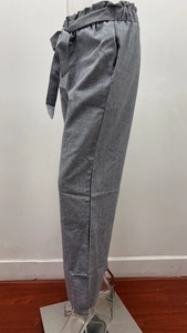 Detail of grey paperbag waist cotton linen trousers with elasticated waistband and fabric belt