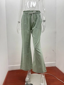 Close-up of high-waisted linen pants with elastic waistband and white drawstring