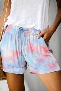 Detail of summer tie-dye shorts featuring pink and blue patterns with elastic drawstring waist