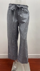 Detailed view of the paperbag high waist and adjustable belt on gray wide-leg linen pants