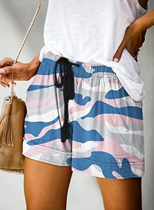 Detail showing high-waisted drawstring design and colorful camouflage pattern shorts