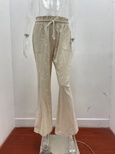 Detail of high waist elastic waistband with white drawstring on beige linen wide leg pants