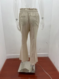 Detail of high waist elastic waistband and dual back pockets on beige linen wide leg pants