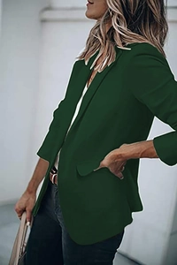 Detailed view of dark green blazer collar and sleeve showing smooth professional fabric