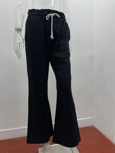 Detail view of cotton linen pants featuring an elastic drawstring waist and side pockets