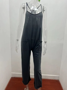 Detailed view of dark grey sleeveless jumpsuit showing large utility patch pockets