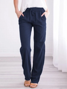 Detail of navy blue cotton linen pants featuring drawstring waist and side pockets