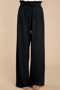 Detail of black paperbag high waist linen trousers with adjustable tie-up bow belt