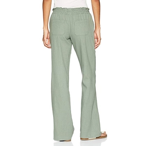 Detail view of cotton linen trousers featuring elastic paper bag waist and rear pockets