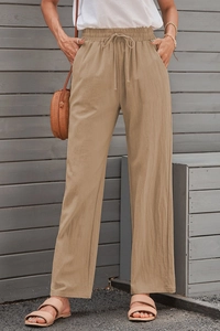Detailed shot of khaki cotton linen trousers with high waist and drawstring cord