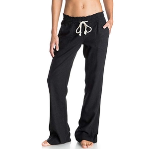 Detail of black cotton linen trousers showing white drawstring waist and side pockets