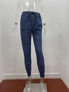 Close-up of leopard print joggers with elastic drawstring waist and cuffed ankles