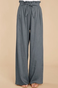 Detail of high waisted grey wide leg linen pants with paperbag waist and bow belt