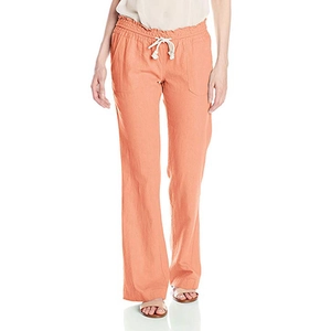 Detail of coral orange cotton linen pants showing drawstring waist and pocket texture