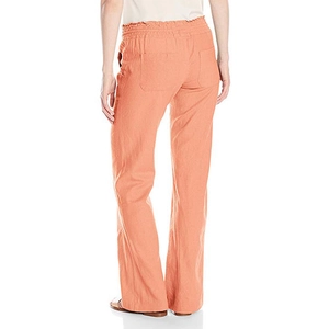 Rear view of coral linen wide leg trousers featuring elastic waistband and back pockets