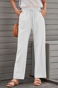 Close-up of white linen wide-leg pants featuring elastic drawstring waist and side pockets