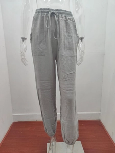 Detail of high waist elastic waistband with drawstring on grey casual trousers