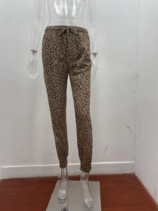 Detail of leopard print joggers featuring elastic drawstring waist and cuffed hem design