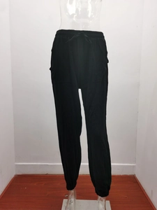 Detail view of black high-waisted jogger pants with drawstring waist and elastic cuffs